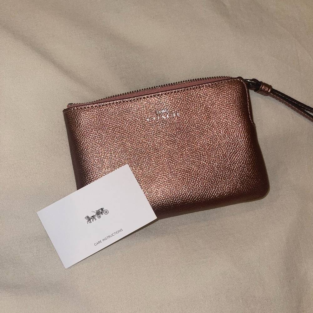 COACH rose gold wristlet